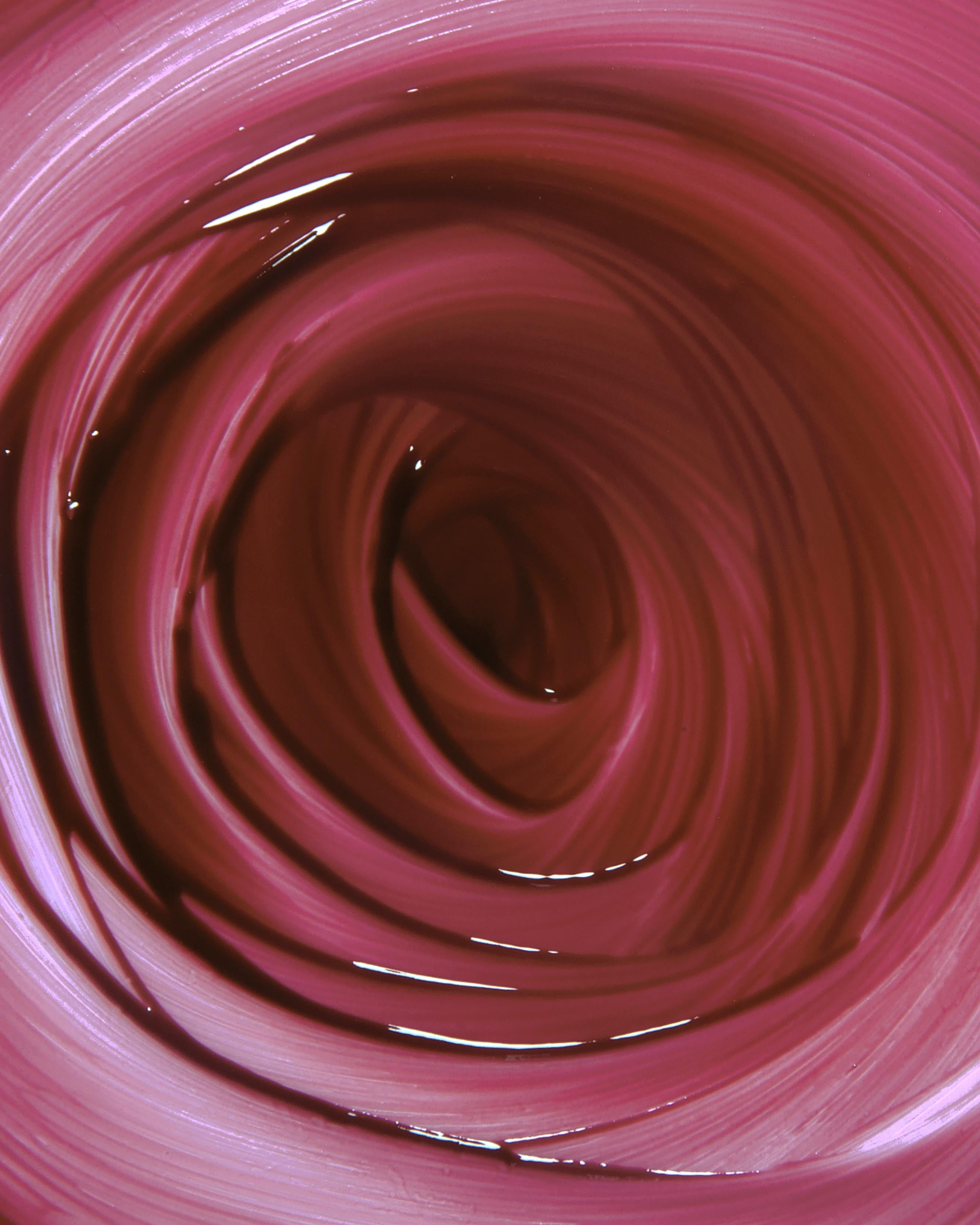 Close-up of burgundy red makeup swirled in a circular pattern